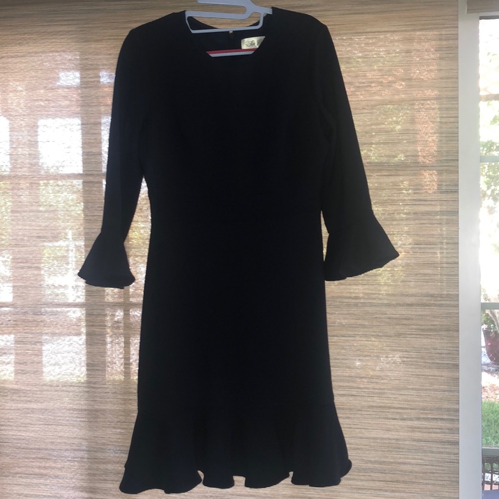 Navy dress with bell cuff detail and ruffle hem